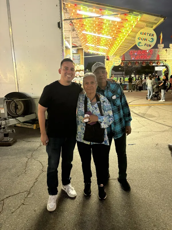 Alfredo Rodriguez with residents at a community fair