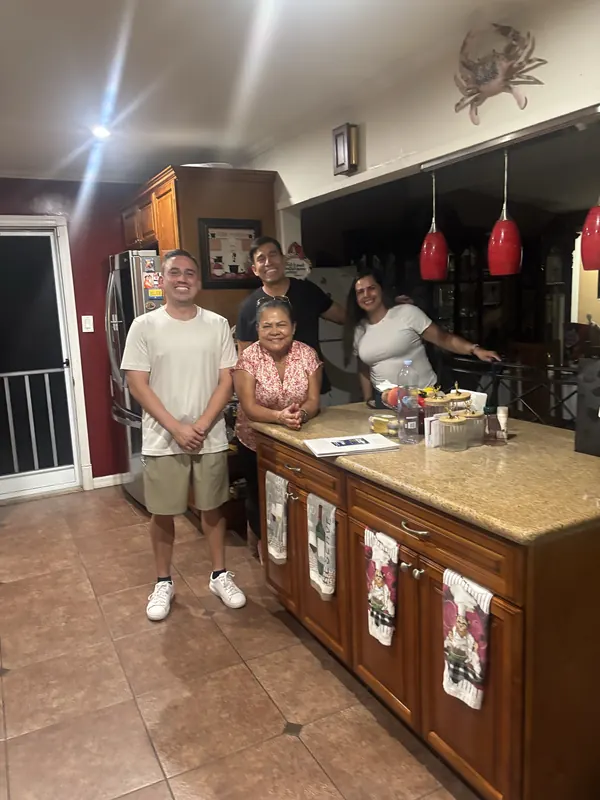 Alfredo Rodriguez visiting a family at home