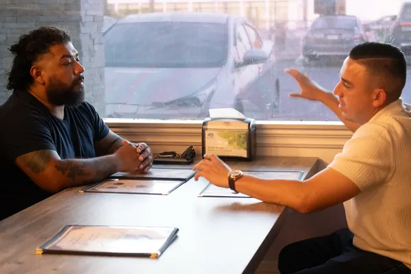 Alfredo Rodriguez meeting one-on-one with a resident