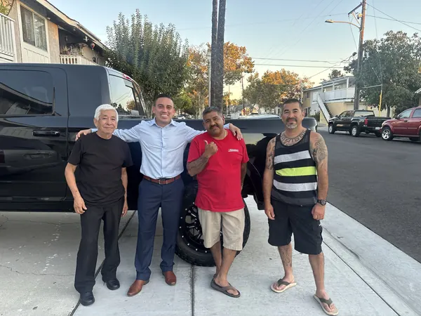 Alfredo Rodriguez with neighbors on the street